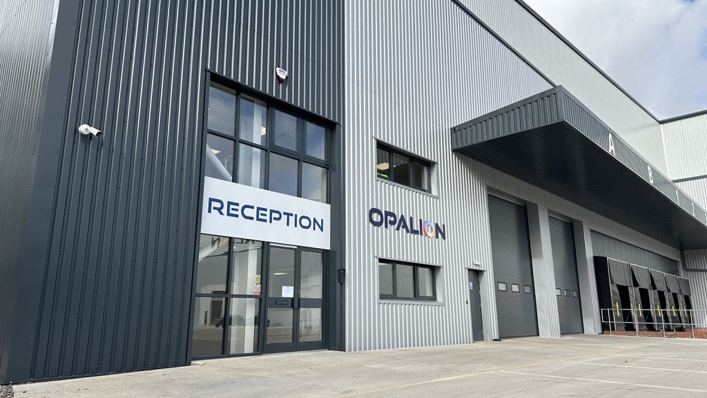 exterior of grey corrugated Opalion warehouse with a large 'Reception' sign and the Opalion logo