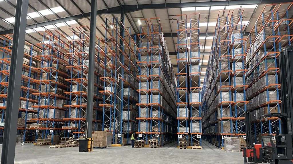 large warehouse with materials stacked high on scaffolding